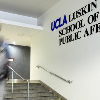 student ascending steps inside Luskin School