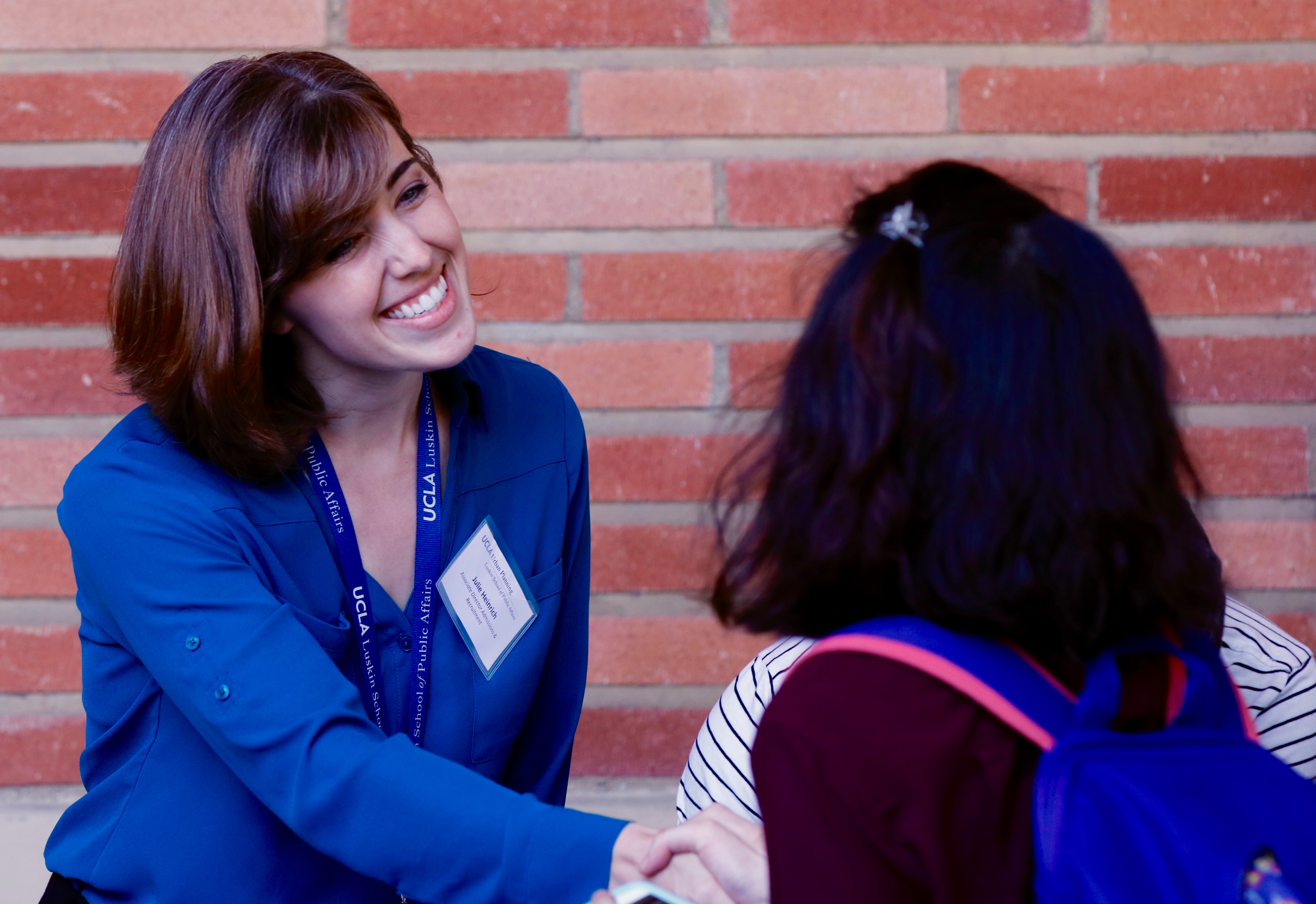 Julie Heinrich, associated director of admissions and recruitment in the Department of Urban Planning, greets a prospective student at Welcome Day. Photo by Les Dunseith