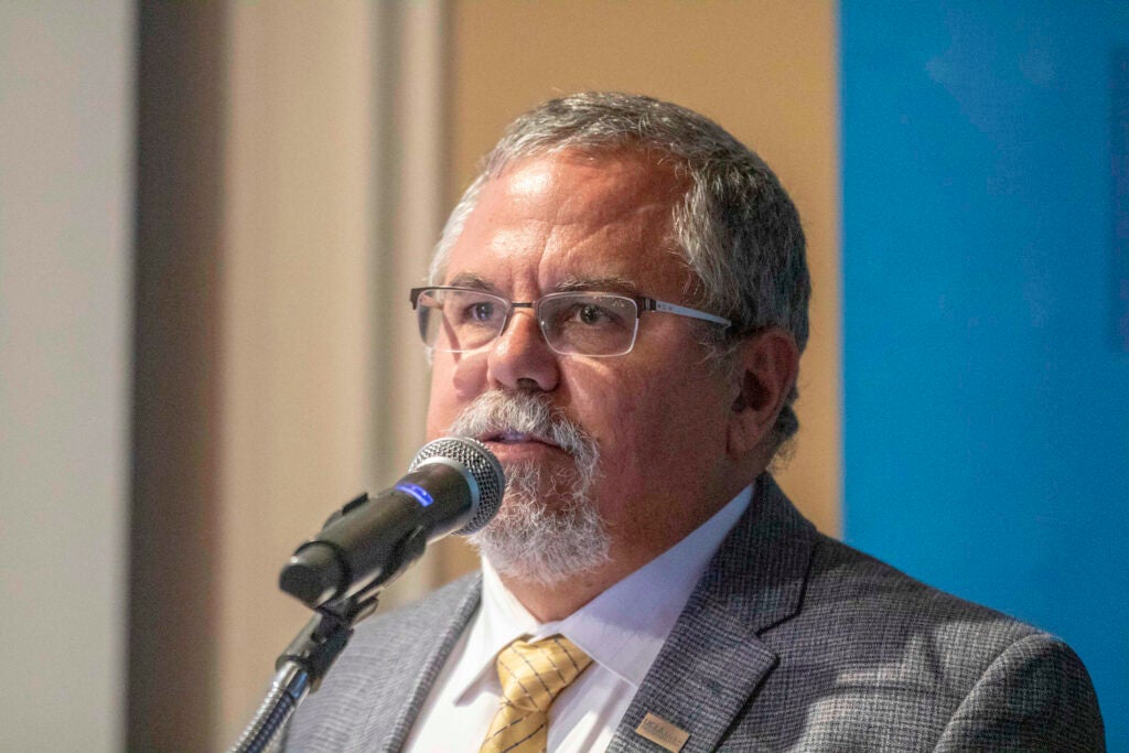 Gary Seguar speaking in front of a microphone