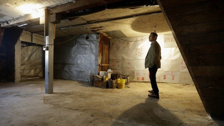 Man standing in unfinished garage