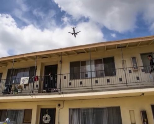 screen capture from video obtained fromthe LA Times of a plane flying over housing in Inglewood