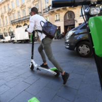 image of person riding a Lime scooter