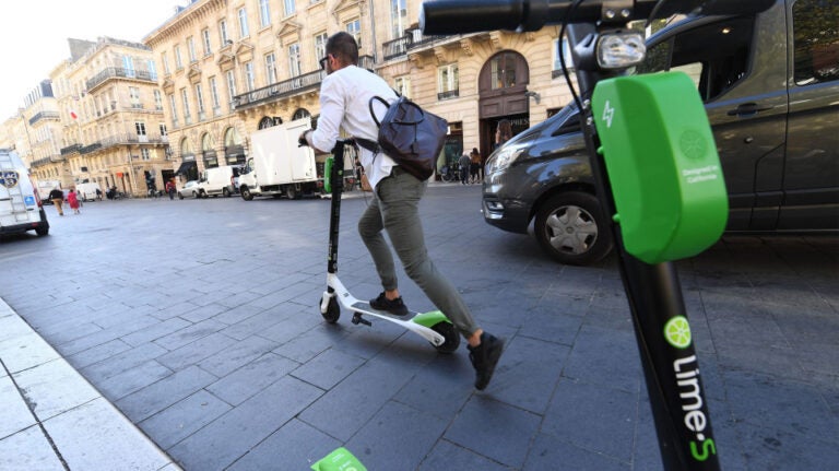 image of person riding a Lime scooter