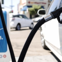 image of a vehicle at a gas station pumping gas