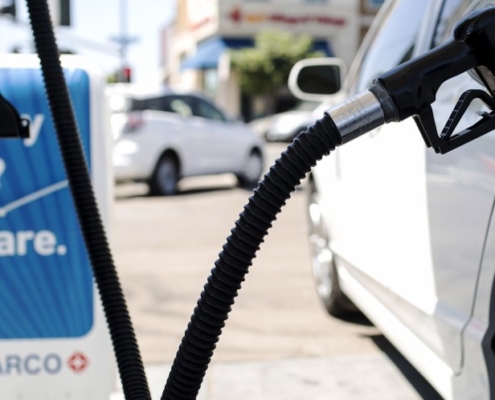 image of a vehicle at a gas station pumping gas