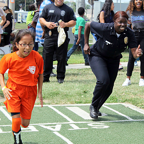 Officer Emada Tingirides races a youngster