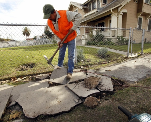 file photo of a broken sidewalk under repair