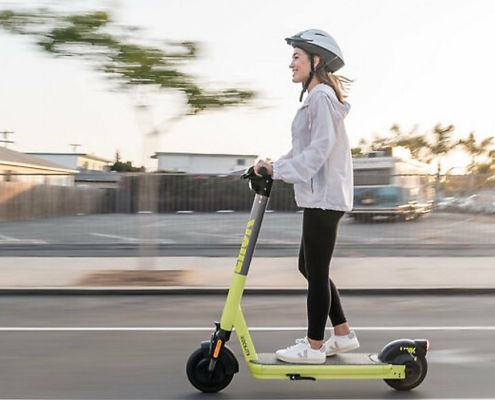 stock image shows a young woman on a scooter