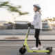 stock image shows a young woman on a scooter