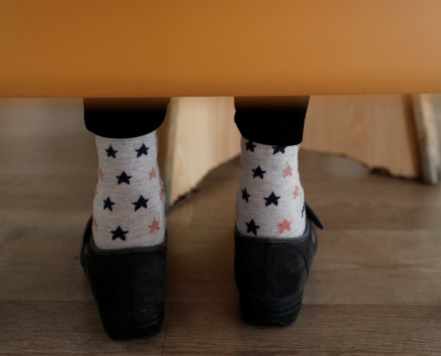 file image of a person's feet under a chair