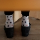 file image of a person's feet under a chair