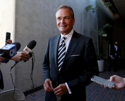 Man in suit being interviewed.