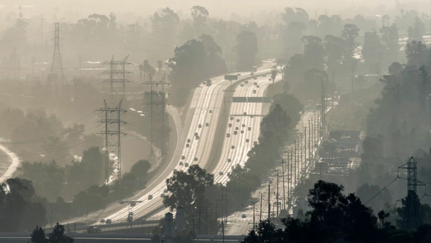 sepia tone shot of freeway shrouded in smog