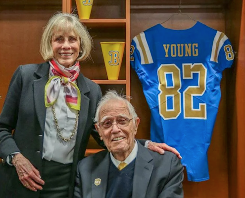 Woman and man in locker room with football jersey