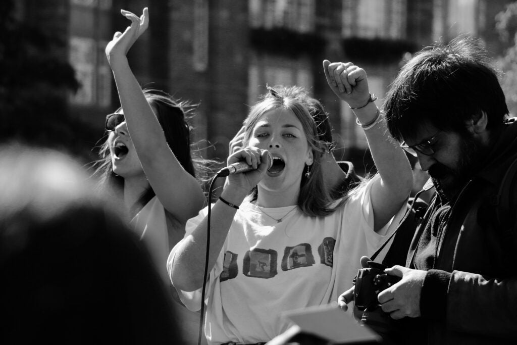 black and white photo of young woman protesting