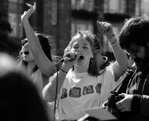 black and white photo of young woman protesting