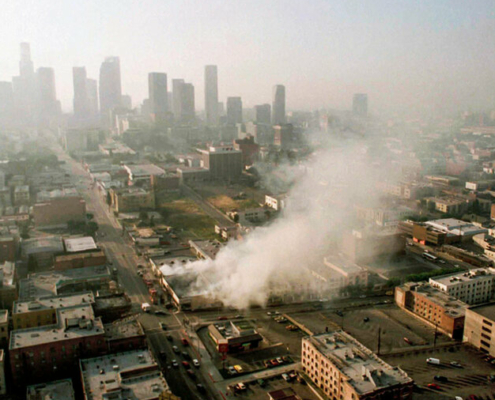 Aerial image of smoke rising from a shopping center in downtown Los Angeles during the 1992 race riots.