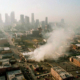 Aerial image of smoke rising from a shopping center in downtown Los Angeles during the 1992 race riots.