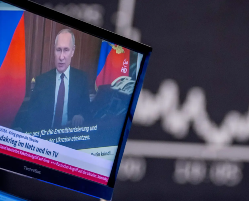 Russia's President Vladimir Putin appears on a television screen at the stock market in Frankfurt, Germany