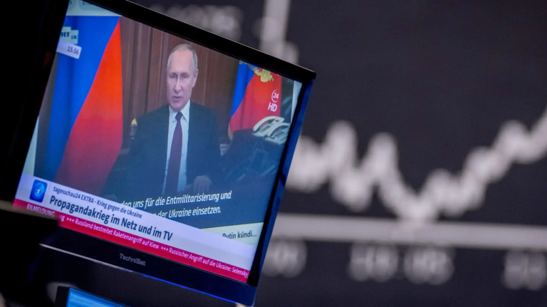 Russia's President Vladimir Putin appears on a television screen at the stock market in Frankfurt, Germany