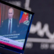 Russia's President Vladimir Putin appears on a television screen at the stock market in Frankfurt, Germany