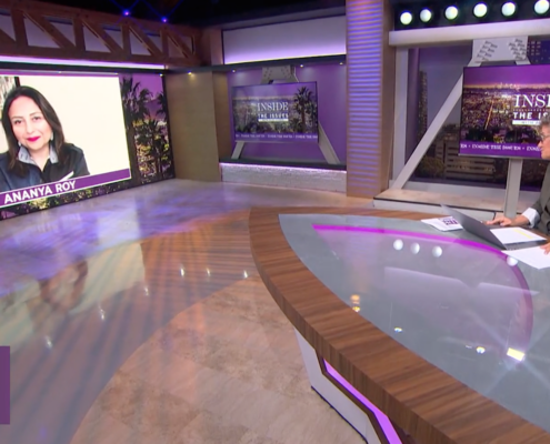 television set with woman at desk and woman on screen