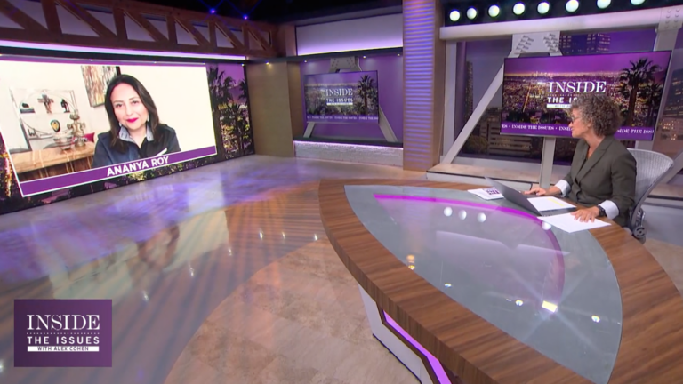 television set with woman at desk and woman on screen