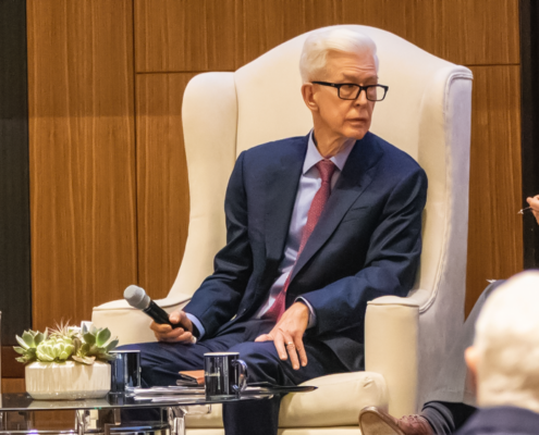 From left in large chairs on a stage during discussion at UCLA are Pete Wilson, Gray Davis and Jim Newton