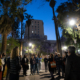 park lighting glows in the background as a group of people gather in an urban park in Los Angeles