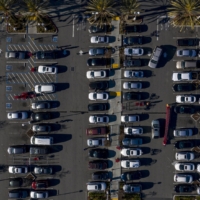 Aerial view of a parking lot filled with cars.