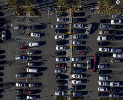 Aerial view of a parking lot filled with cars.
