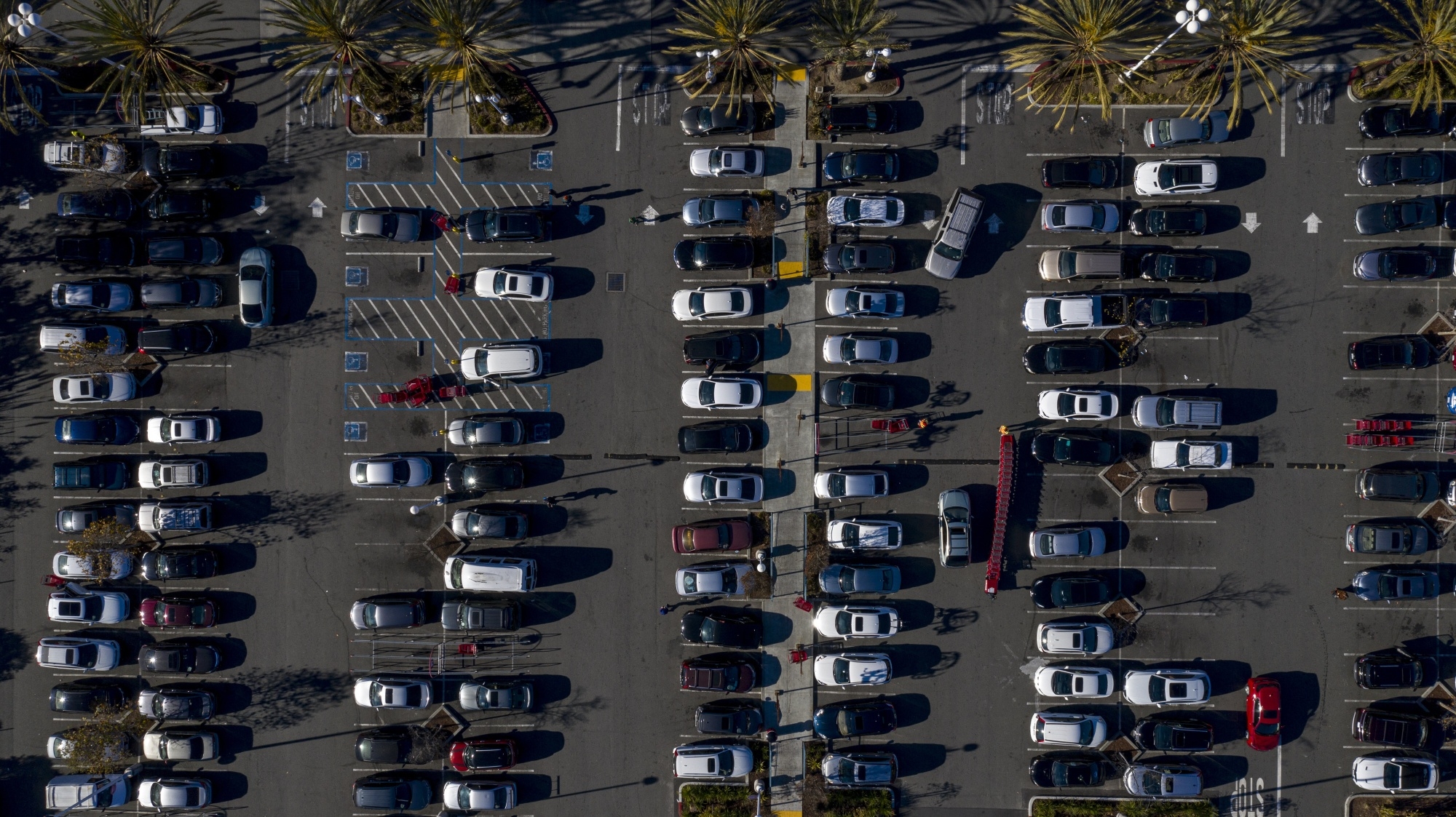 Aerial view of a parking lot filled with cars.