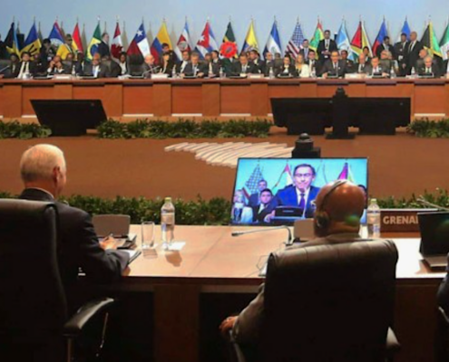 delegats at conference tables with international flags