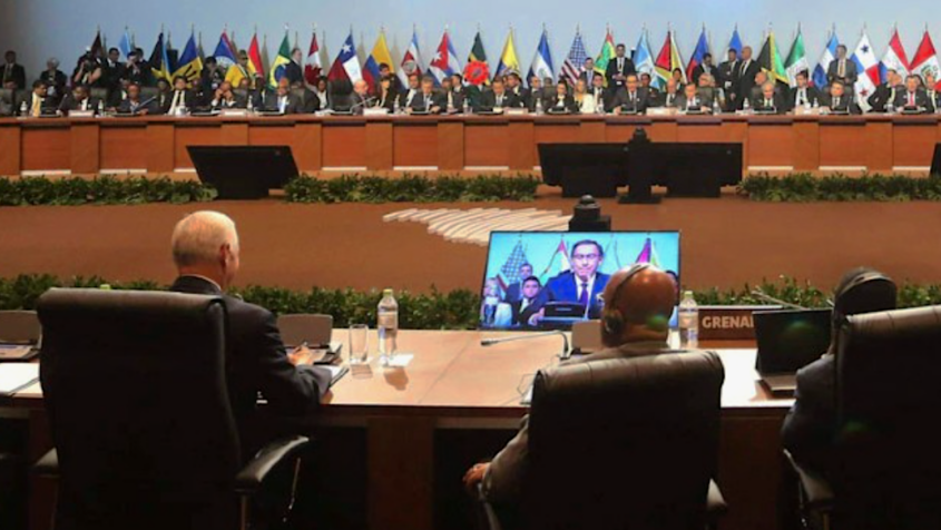 delegats at conference tables with international flags