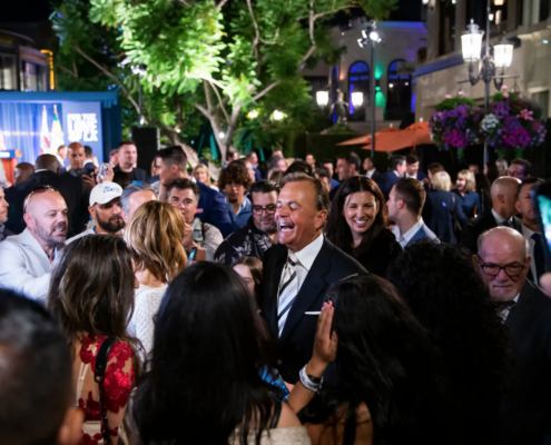 Man in suit in crowded outdoor venue