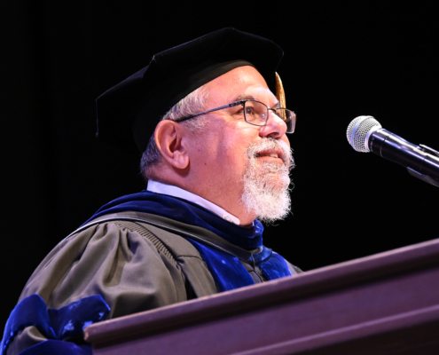 graduation speaker with beard at podium