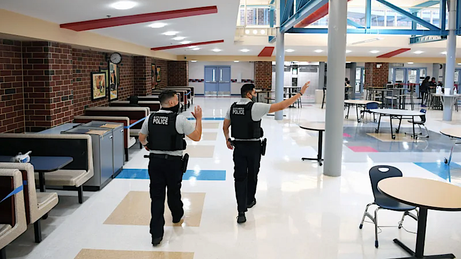two school police officers in campus cafeteria