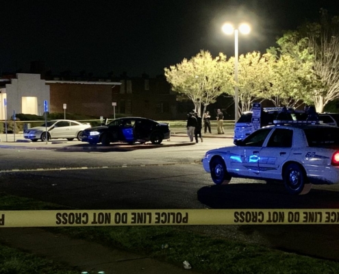 Police cars are parked behind yellow caution tape in front of a church in Alabama.