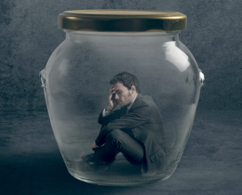 illlustration with man in suit inside glass jar