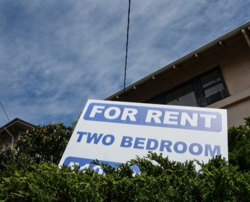 For Rent sign in front of apartment building