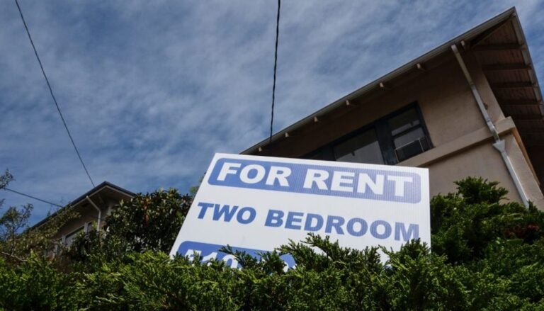 For Rent sign in front of apartment building