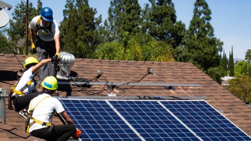 Roofers installing solar panels