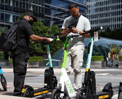 two men near electric scooters for rent