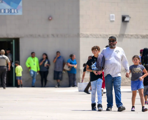 Parents and children outside school building