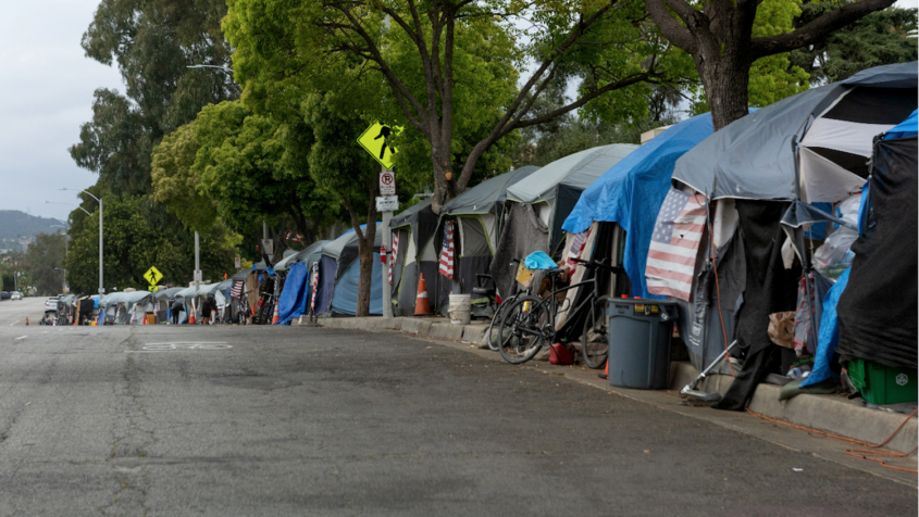 sidewalk lined with tents housing homeless people