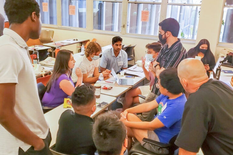 young people huddle in discussion