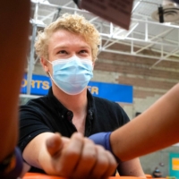Masked young man receiving vaccine