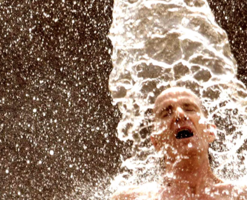 Man in splash pool, with only head visible