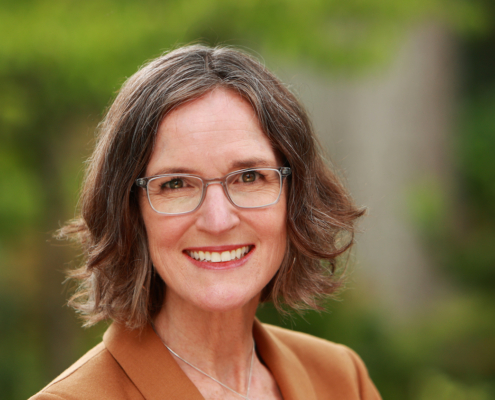 woman with glasses and short brown hair