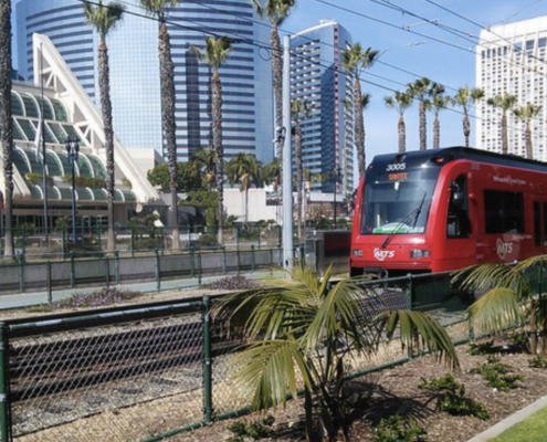 Light rail in front of city skyline